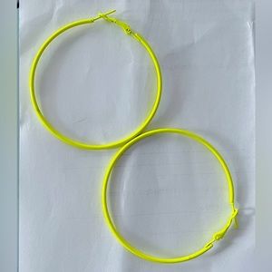 Big neon green hoop earrings.